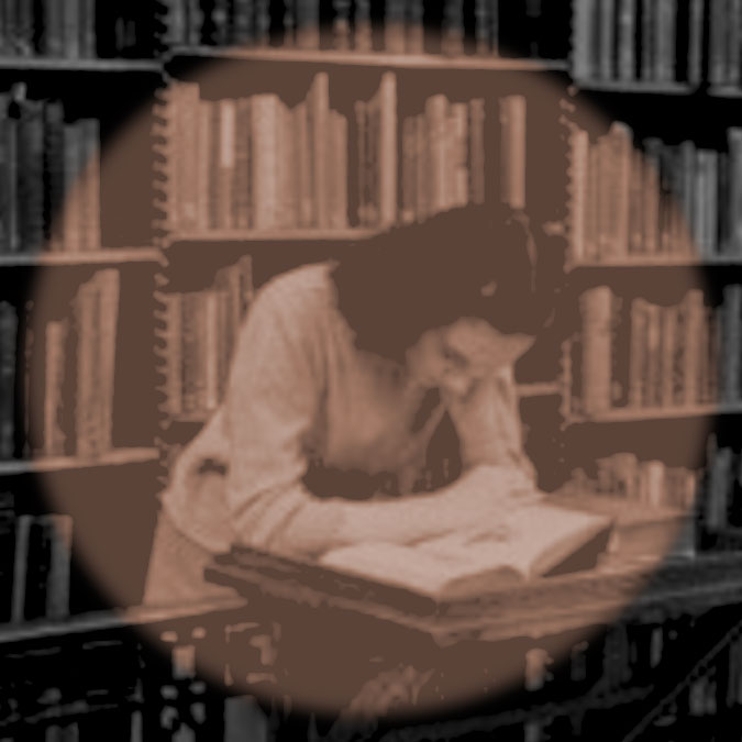 Woman reading in library with spotlight